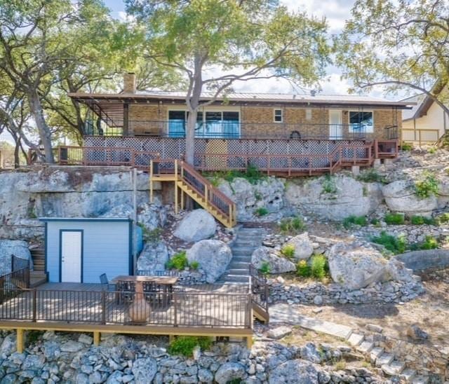 back of property with a wooden deck