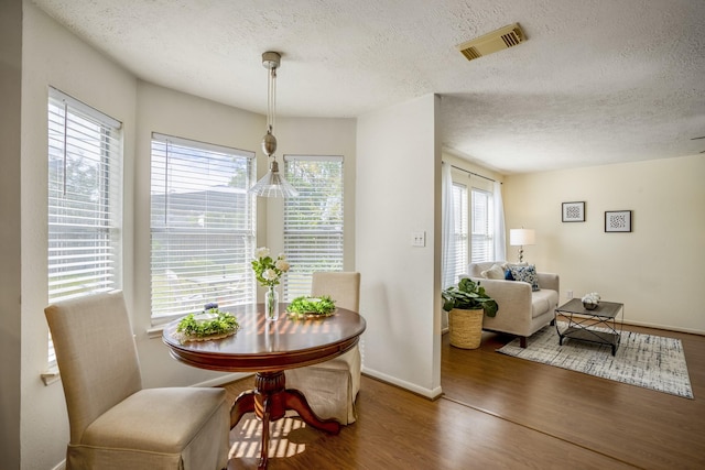 dining area featuring hardwood / wood-style flooring and a healthy amount of sunlight