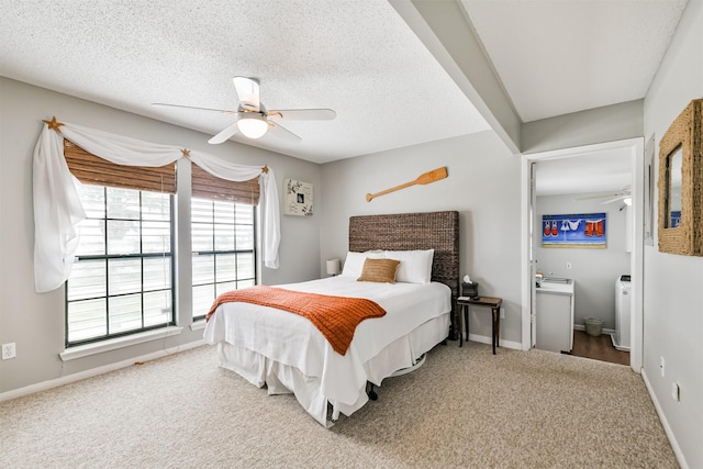 carpeted bedroom with a textured ceiling, ceiling fan, and connected bathroom