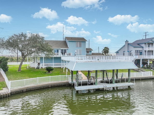 view of dock with a yard and a deck with water view