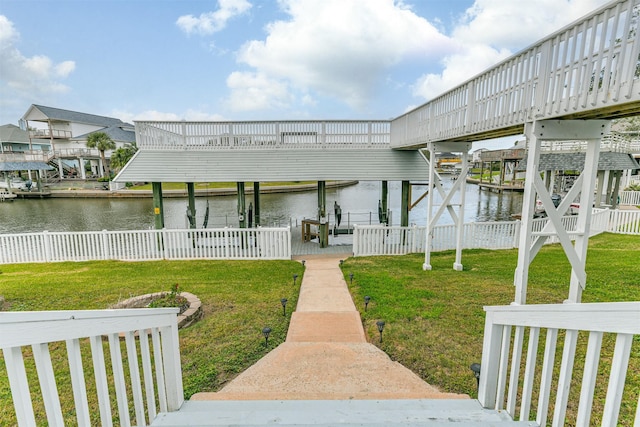 view of dock featuring a lawn and a water view