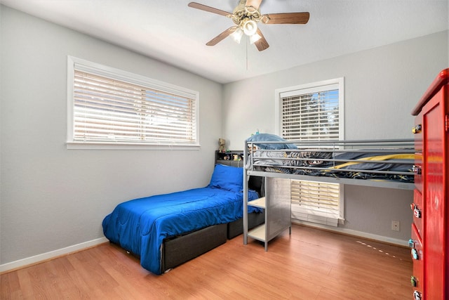 bedroom with hardwood / wood-style floors and ceiling fan