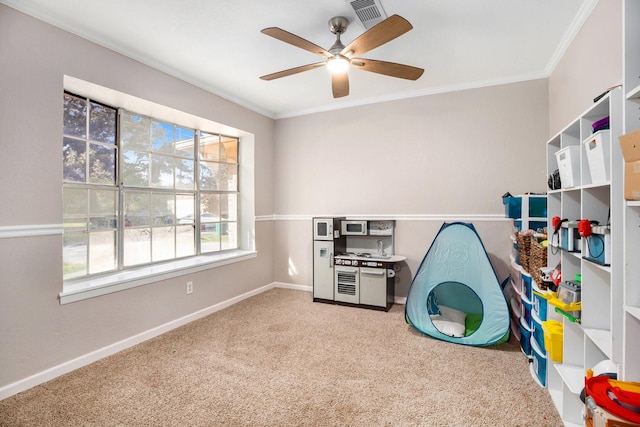 game room featuring carpet flooring, ceiling fan, and ornamental molding