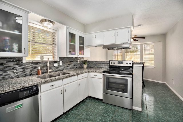 kitchen with white cabinetry, sink, stainless steel appliances, and light stone counters