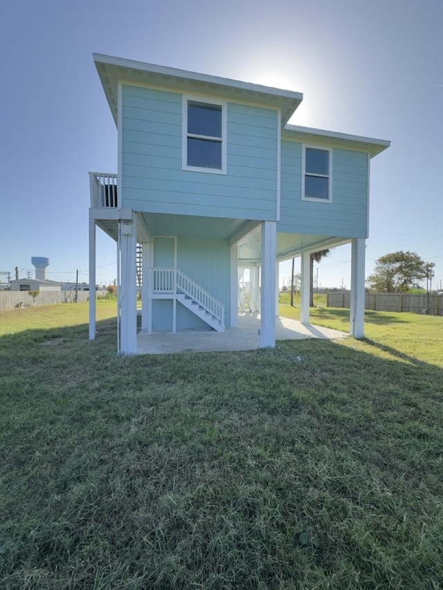 back of house with a lawn