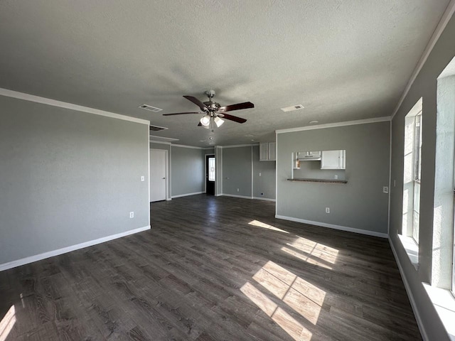 unfurnished living room with a textured ceiling, dark hardwood / wood-style floors, and ornamental molding