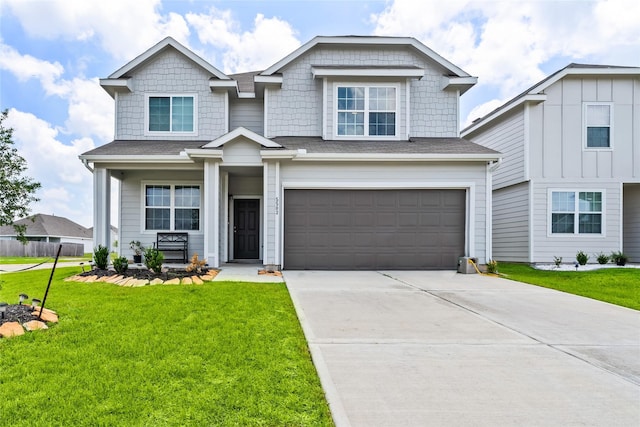 view of front of property with a garage and a front lawn