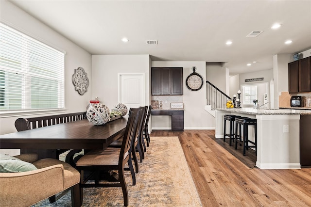 dining room with light hardwood / wood-style floors and a wealth of natural light