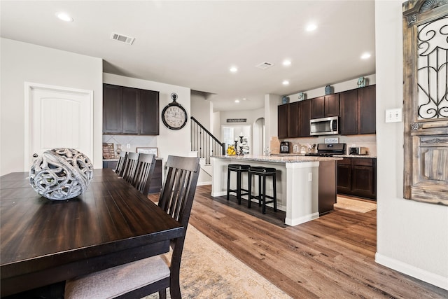 dining space featuring wood-type flooring