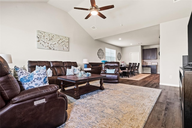 living room with lofted ceiling, ceiling fan, and dark hardwood / wood-style floors