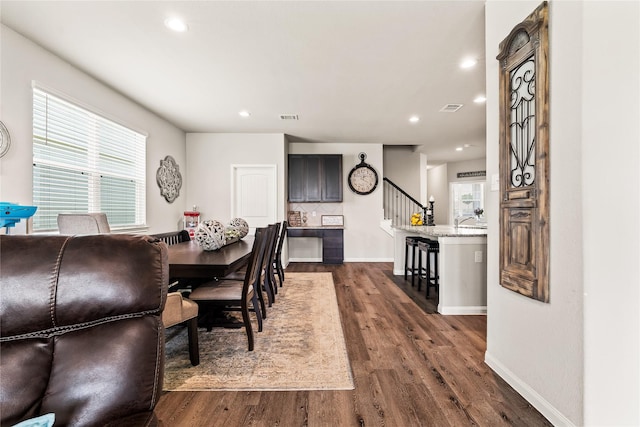 dining room with dark hardwood / wood-style flooring and sink