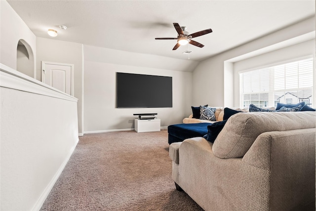 carpeted living room with ceiling fan and vaulted ceiling