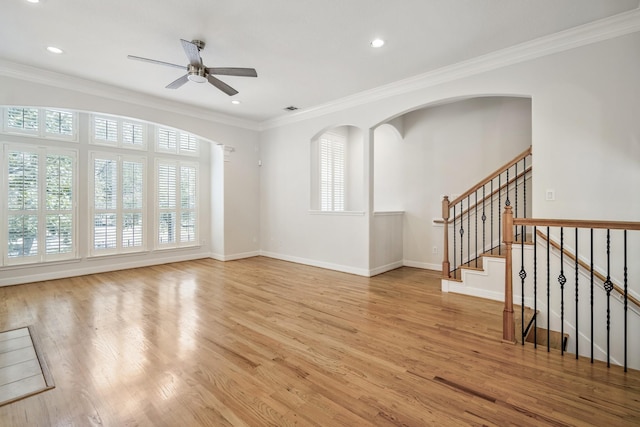 empty room featuring crown molding, ceiling fan, and light wood-type flooring