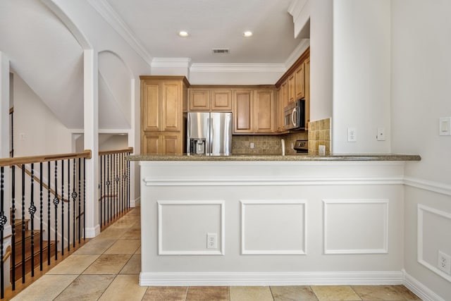 kitchen featuring tasteful backsplash, ornamental molding, light stone counters, kitchen peninsula, and stainless steel appliances