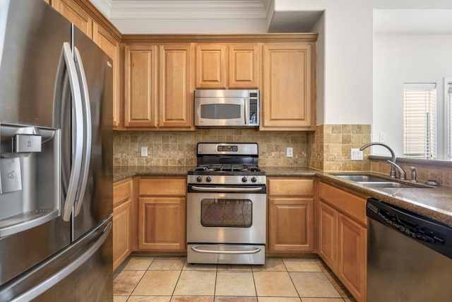 kitchen with tasteful backsplash, stainless steel appliances, light tile patterned flooring, and sink