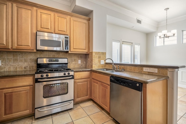 kitchen featuring sink, backsplash, ornamental molding, kitchen peninsula, and stainless steel appliances