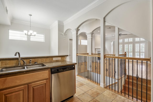 kitchen with light tile patterned flooring, decorative light fixtures, sink, ornamental molding, and stainless steel dishwasher