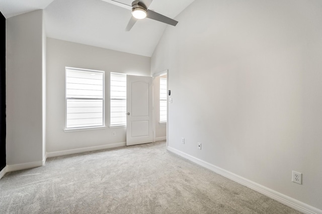 unfurnished bedroom featuring high vaulted ceiling, light colored carpet, and ceiling fan