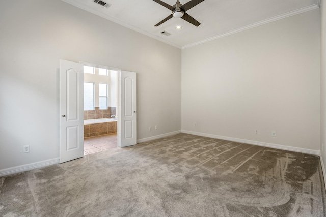 carpeted spare room with crown molding and ceiling fan