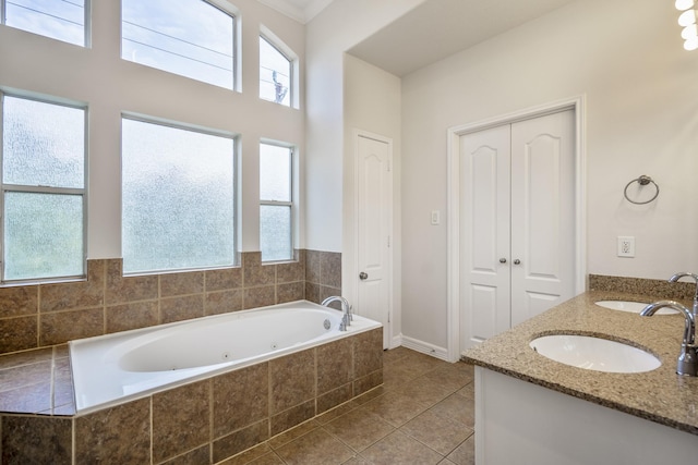 bathroom featuring vanity, tiled bath, and tile patterned floors