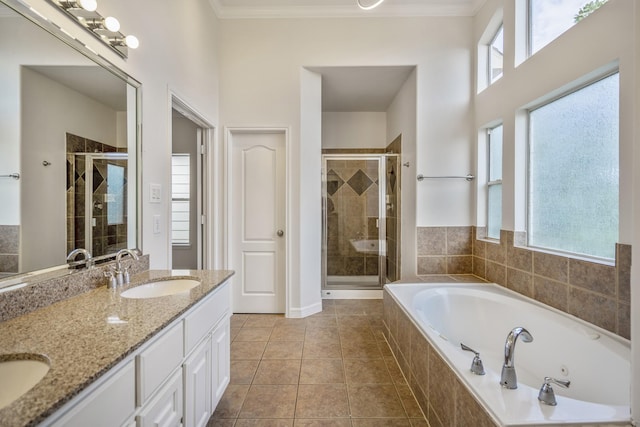 bathroom with independent shower and bath, crown molding, tile patterned flooring, and vanity