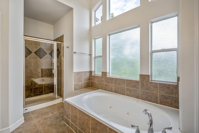 bathroom with tile patterned flooring and independent shower and bath