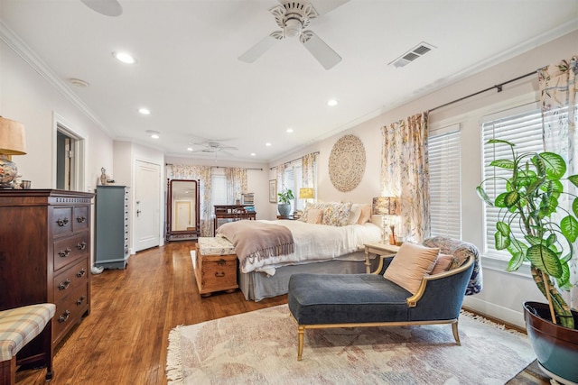 bedroom with ceiling fan, wood-type flooring, and ornamental molding