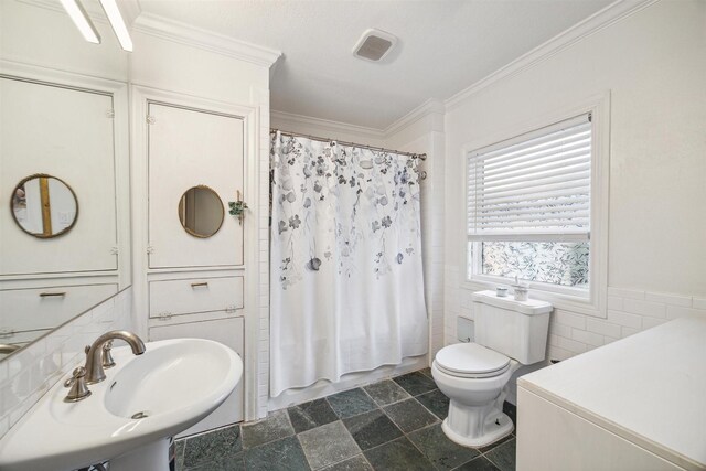 full bathroom with shower / bath combo with shower curtain, crown molding, sink, tile walls, and toilet