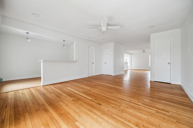 unfurnished living room featuring ceiling fan and light wood-type flooring