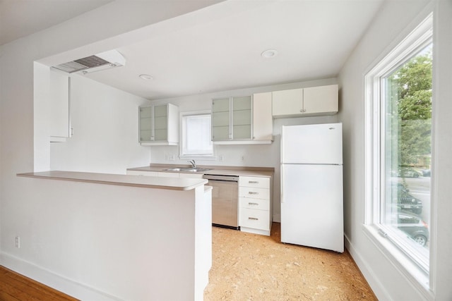 kitchen with sink, light hardwood / wood-style flooring, stainless steel dishwasher, white refrigerator, and kitchen peninsula