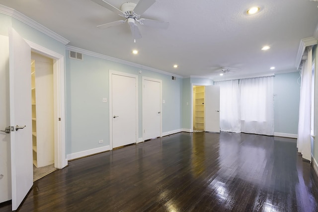 spare room featuring crown molding, ceiling fan, and dark wood-type flooring