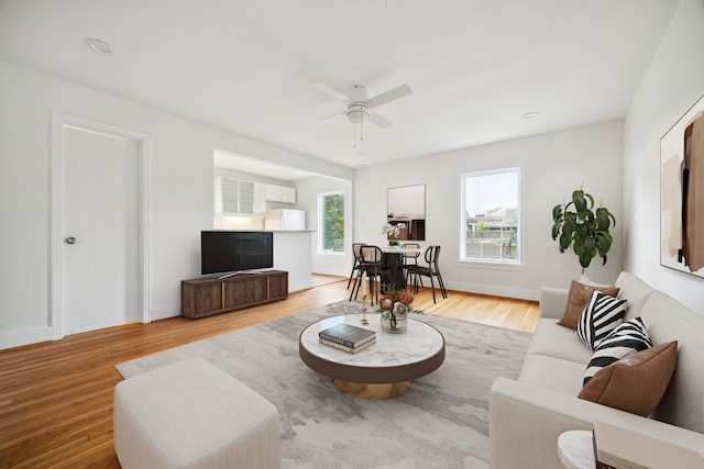 living room featuring hardwood / wood-style floors, plenty of natural light, and ceiling fan