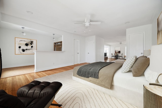 bedroom with ceiling fan and light hardwood / wood-style floors