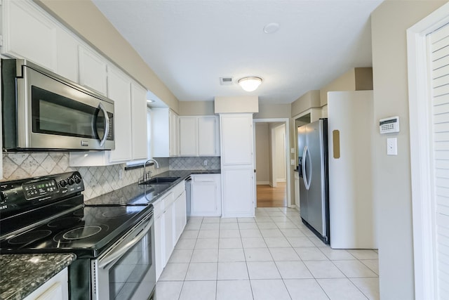 kitchen with white cabinetry, sink, appliances with stainless steel finishes, and tasteful backsplash