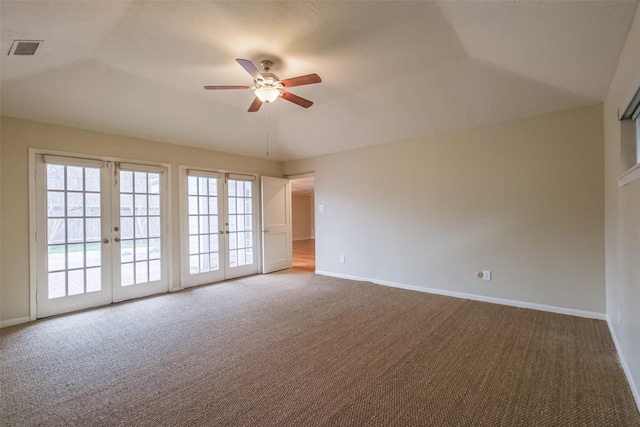 empty room featuring french doors, carpet floors, ceiling fan, and lofted ceiling