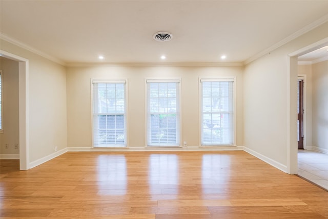 empty room with light hardwood / wood-style flooring and ornamental molding