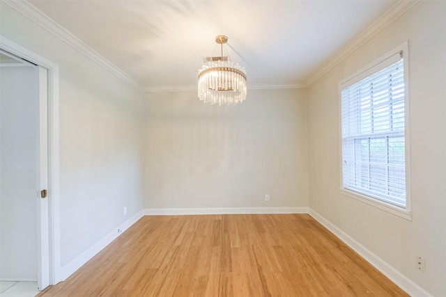 unfurnished room featuring light hardwood / wood-style floors, crown molding, and an inviting chandelier