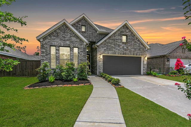 view of front of home featuring a lawn and a garage