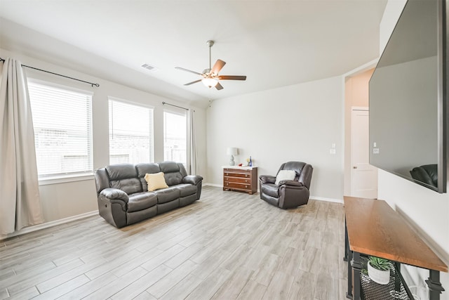 living room featuring light hardwood / wood-style floors and ceiling fan