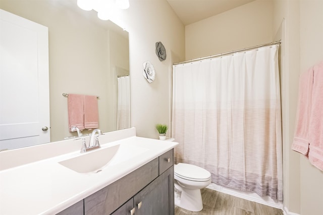 bathroom featuring toilet, vanity, and hardwood / wood-style flooring