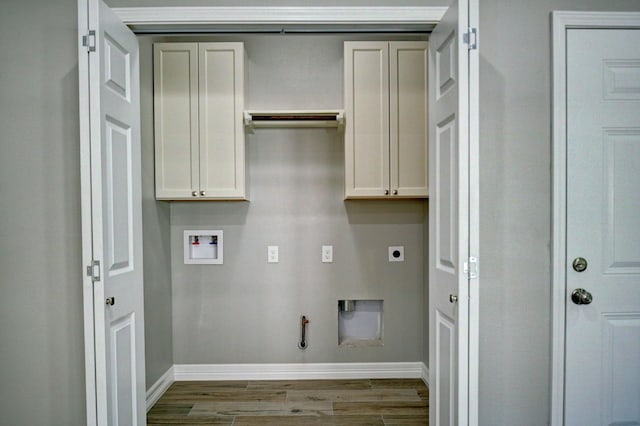 clothes washing area featuring gas dryer hookup, cabinets, washer hookup, electric dryer hookup, and light wood-type flooring