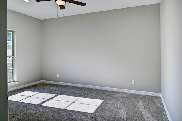 carpeted spare room with ceiling fan