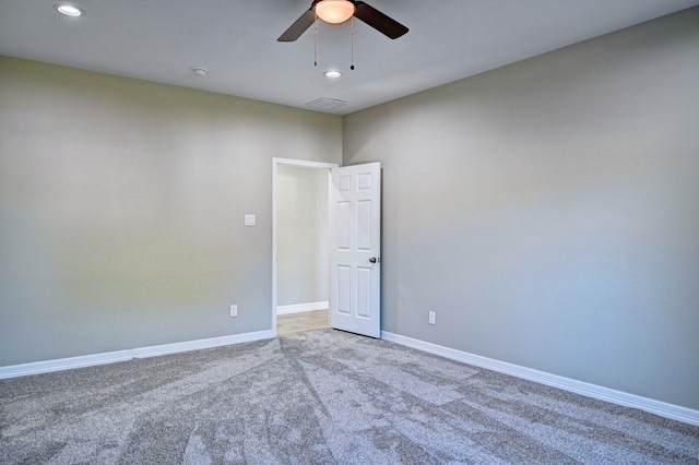 spare room with carpet floors and ceiling fan