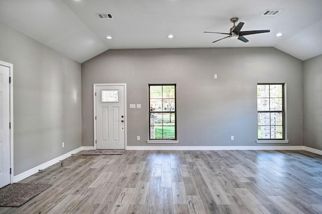 entrance foyer with lofted ceiling, a wealth of natural light, ceiling fan, and light hardwood / wood-style flooring