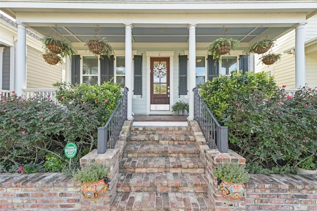 view of exterior entry with covered porch