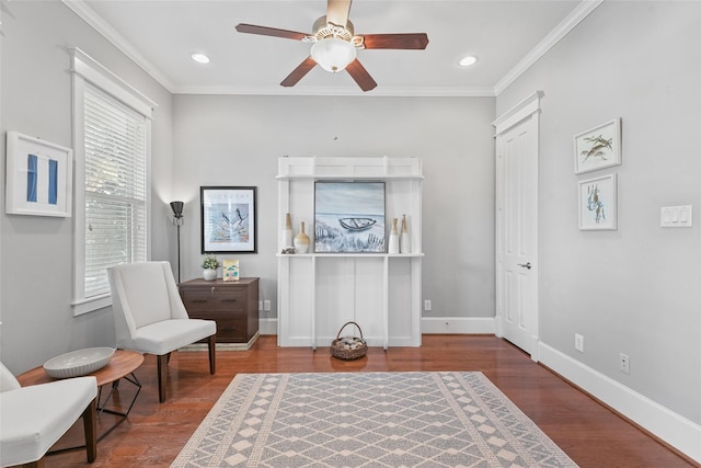 sitting room featuring ceiling fan, wood-type flooring, and crown molding