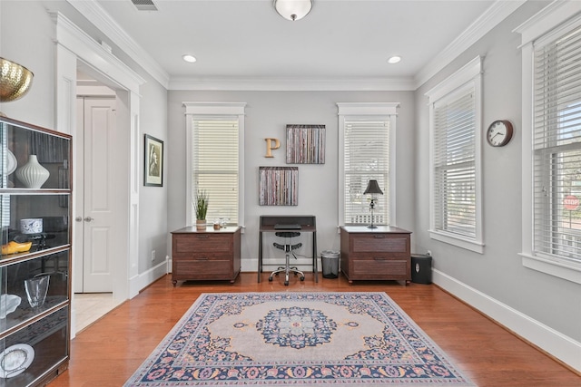 living area featuring crown molding and light hardwood / wood-style floors