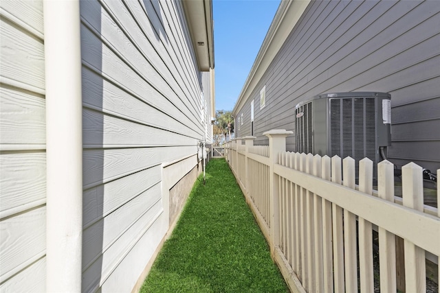 view of side of home with central air condition unit