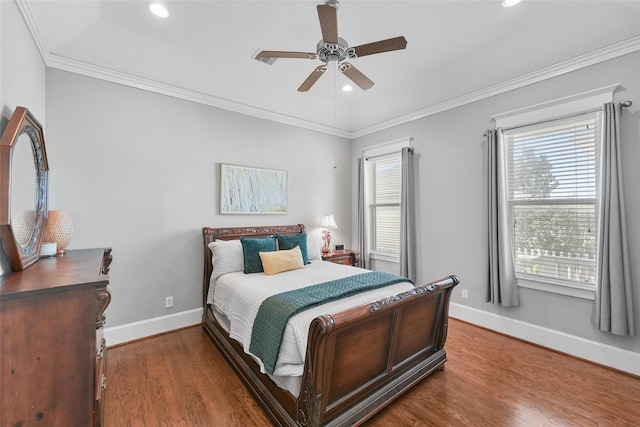 bedroom with hardwood / wood-style floors, ceiling fan, and multiple windows