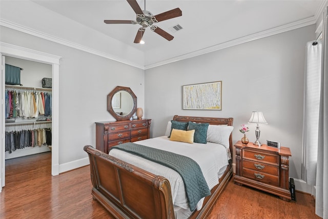 bedroom featuring dark hardwood / wood-style flooring, ceiling fan, a closet, and ornamental molding